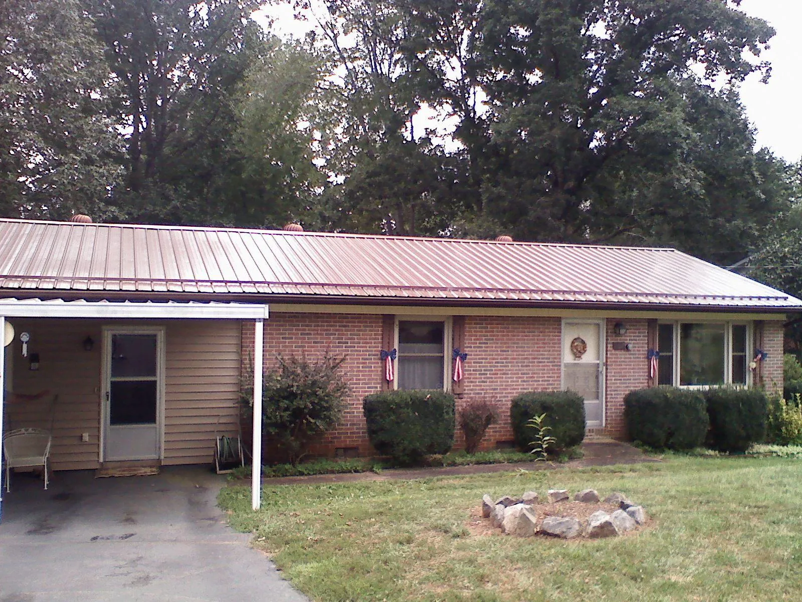 Bronze metal roof and carport on a brick ranch home — Roof Repair work by our crew in Petaluma